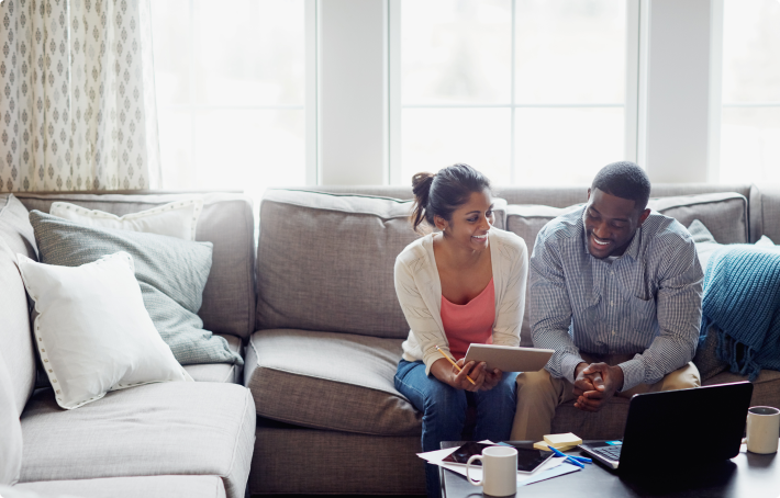 Image of couple reviewing their annuity options, while sitting on the couch
