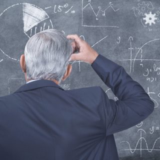 Confused man working on formula