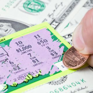 Scratching off a winning scratch ticket with a penny