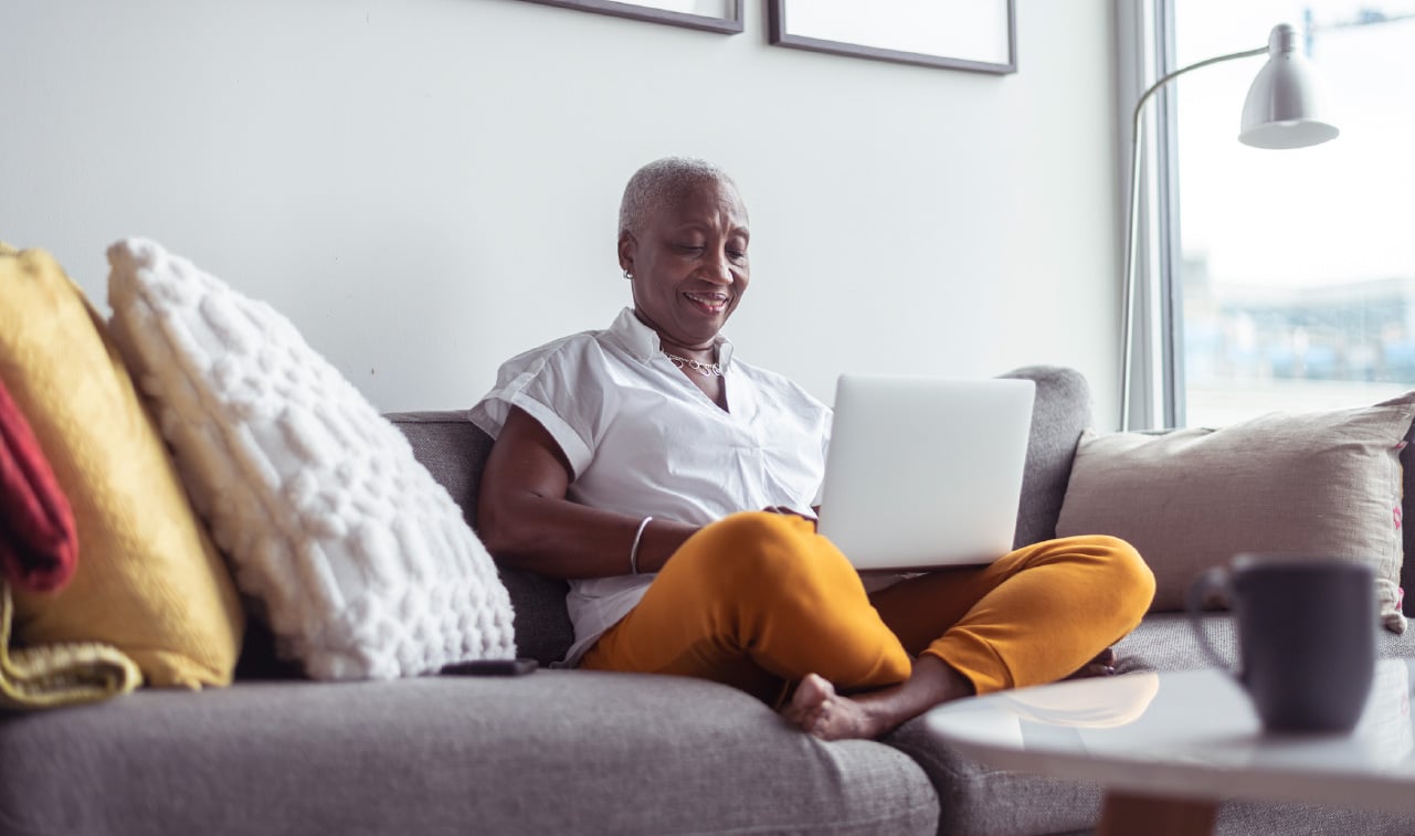 Senior Lady on couch using laptop