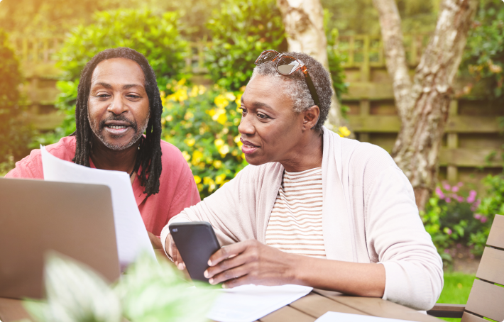 Middle-aged couple outside on their patio talking about their financial future