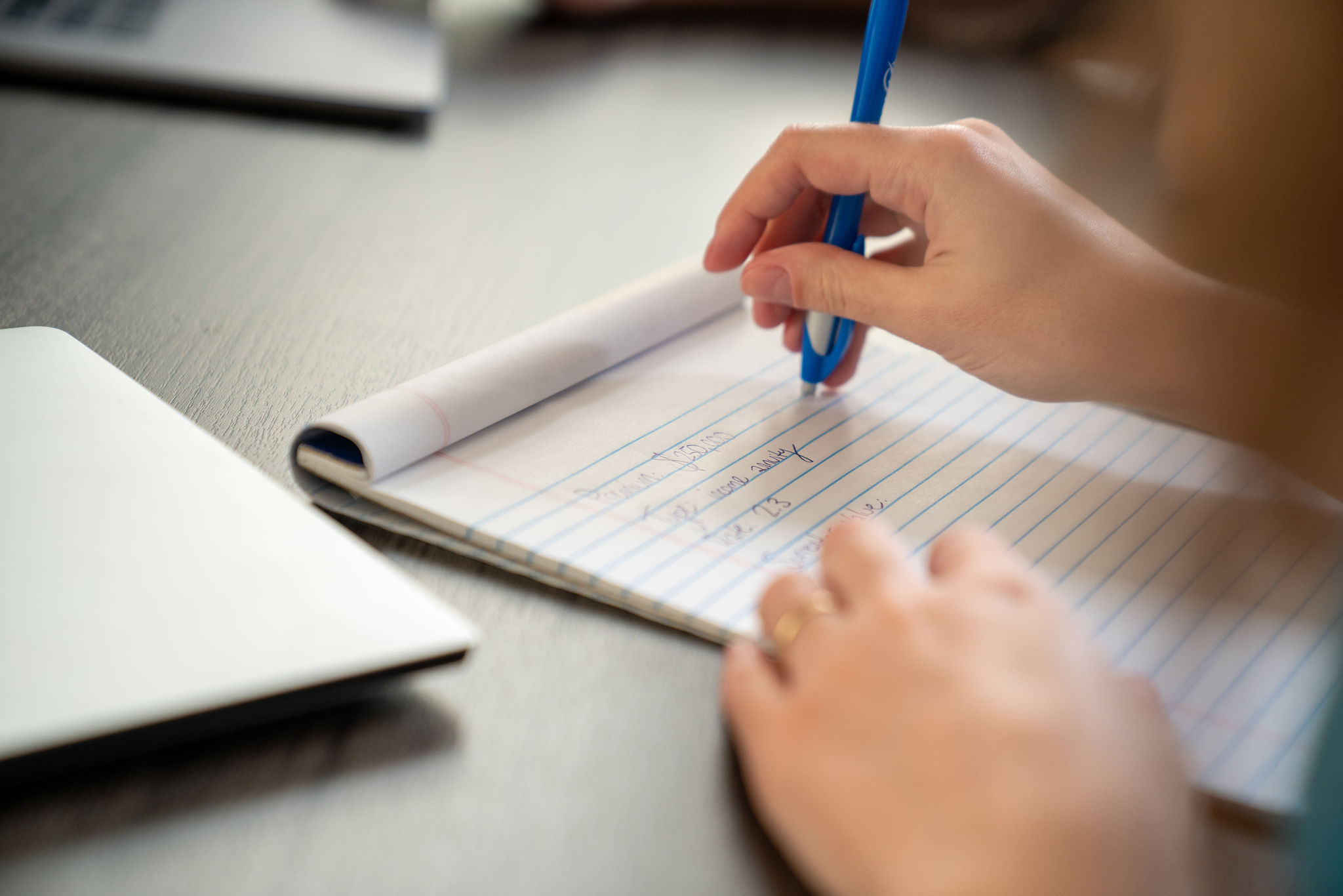 Person writing on notepad
