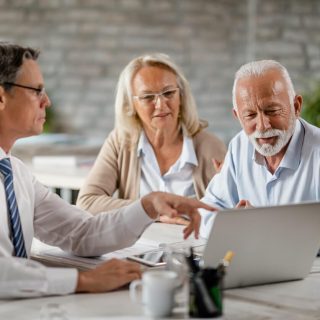 Broker discussing annuities with older couple