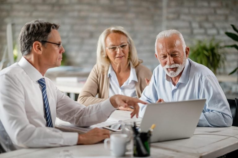 Broker discussing annuities with older couple