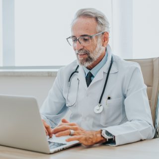 Doctor sitting at a computer