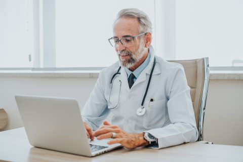 Doctor sitting at a computer