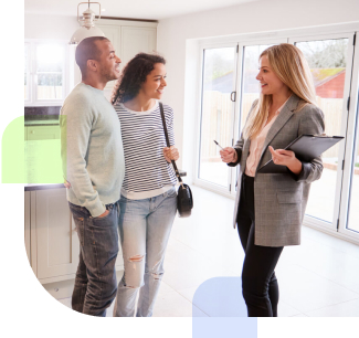 Couple talking with a realtor inside a house for sale
