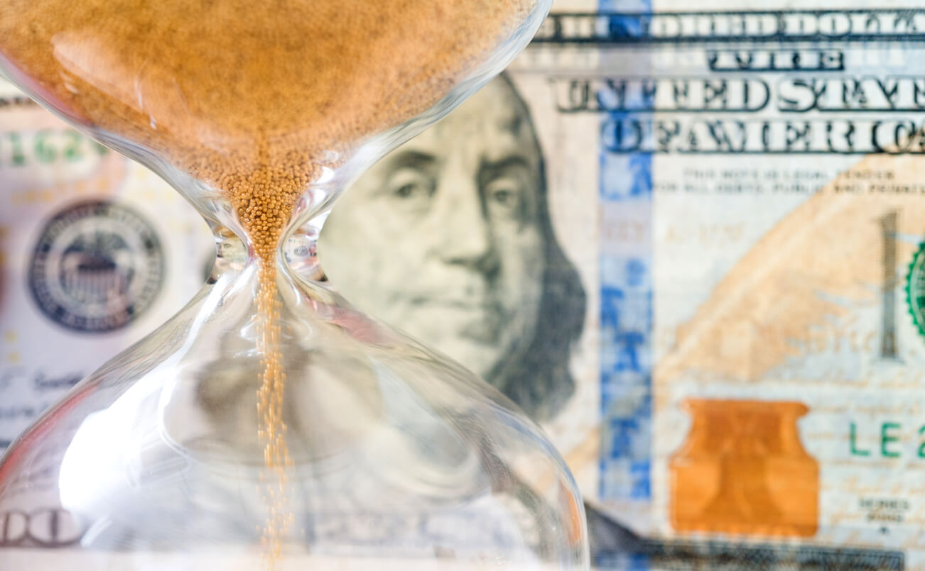 Hourglass in front of money