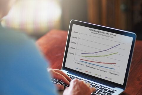 Man managing retirement plan on laptop