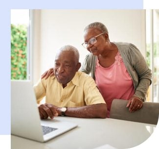 Elderly couple reading about social security online