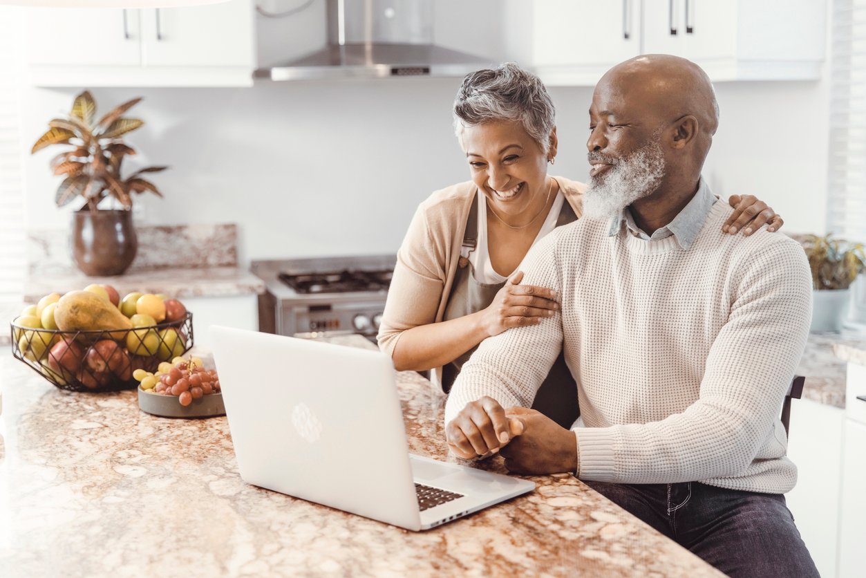 A happy couple celebrates achieving a financial goal