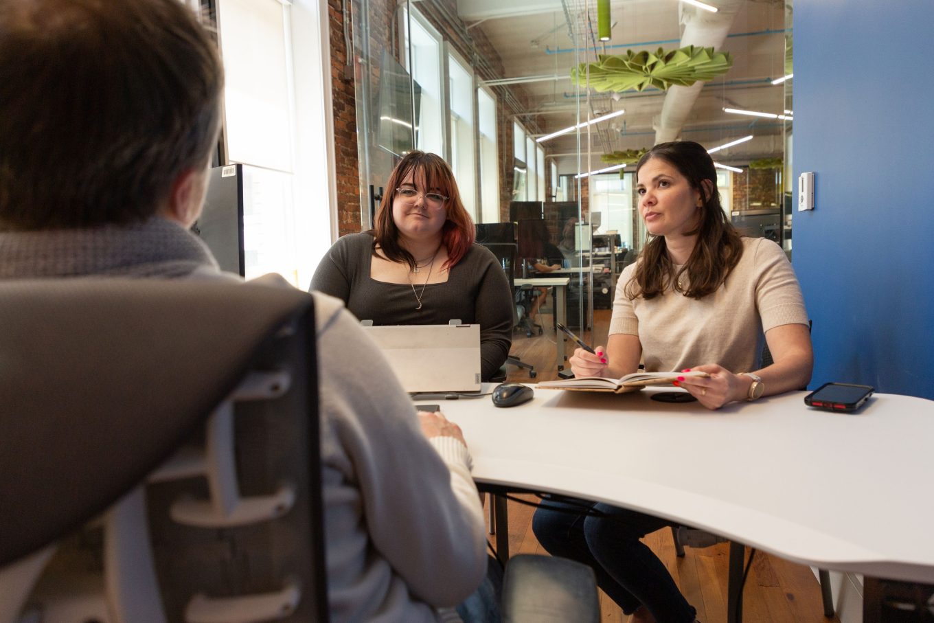 Annuity.org marketing team talking strategy at a desk