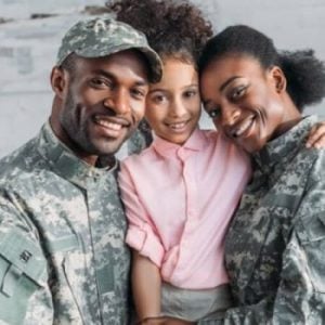 Soldiers embracing their daughter