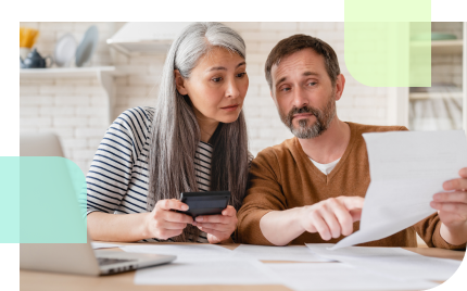 Mature couple calculating bills that may require them to cash out their annuity