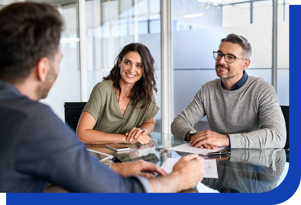 Couple sitting at a desk, meeting with financial advisor