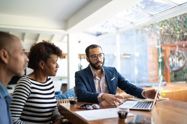 Couple speaking with financial advisor