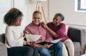 Family sitting on couch, talking about financial plans