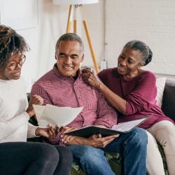 Family sitting on couch, talking about financial plans