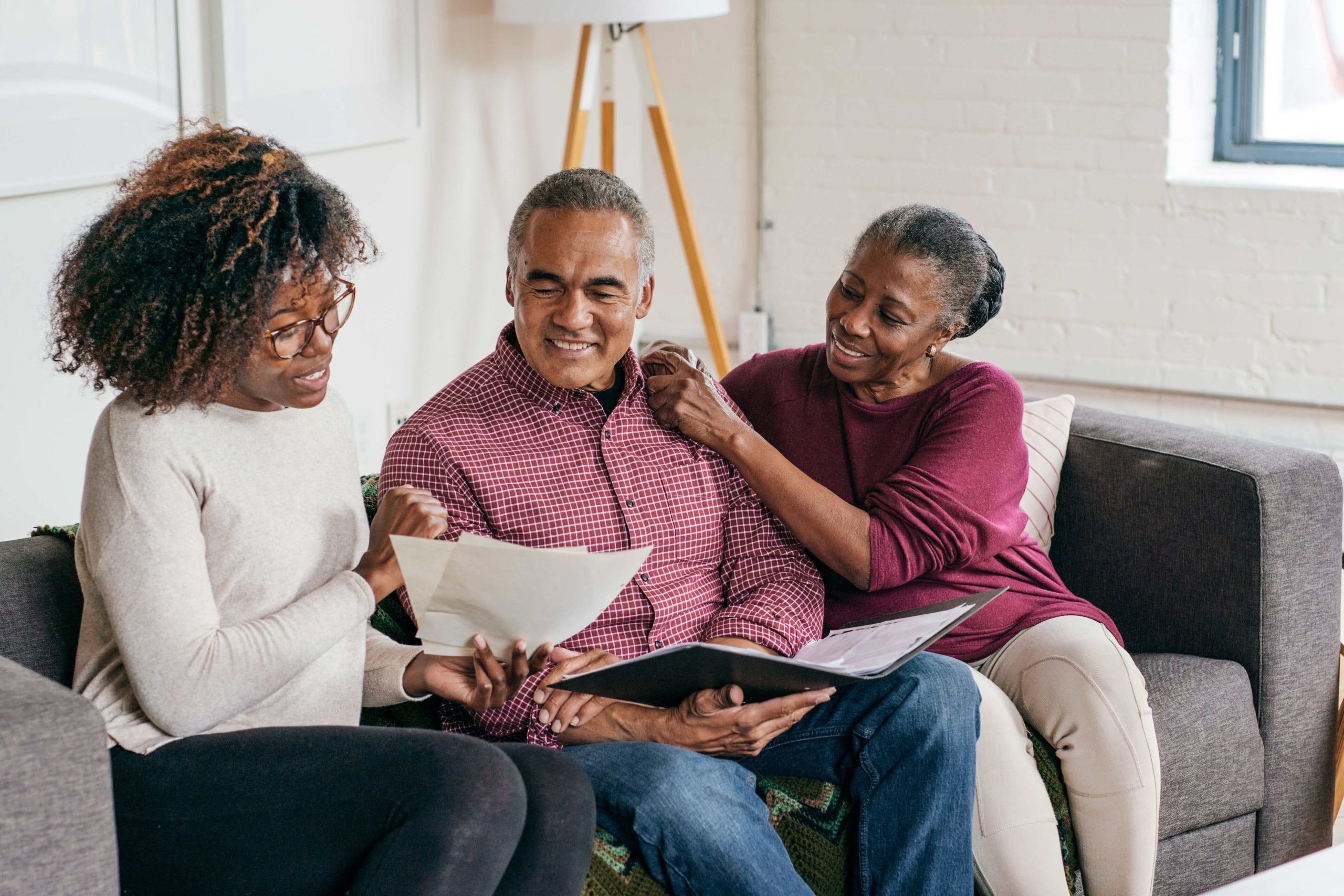 Family sitting on couch, talking about financial plans