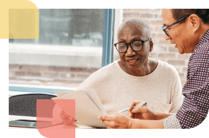 Financial advisor explains to an older African American woman how annuities work