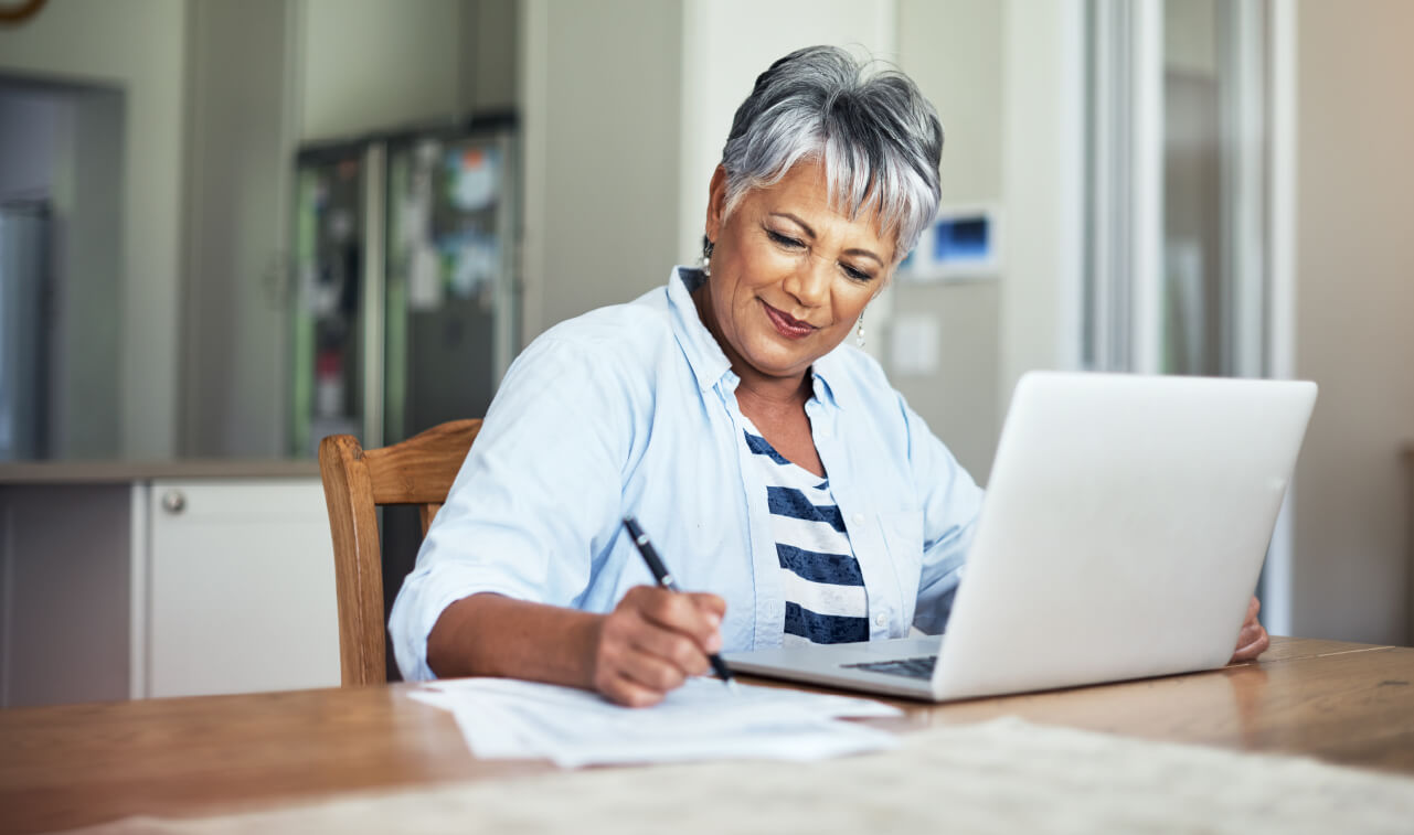 photograph of a senior woman learning about finances online