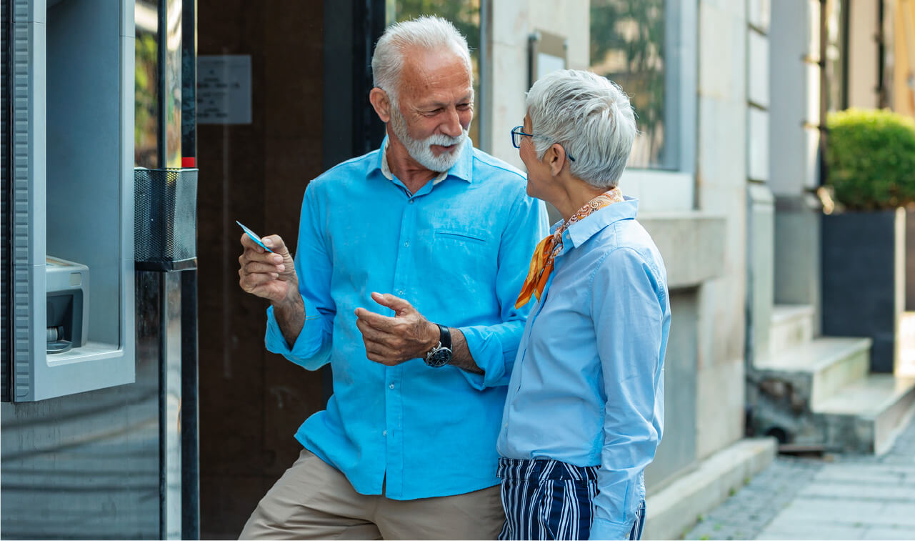 Elderly couple walking down the street and talking