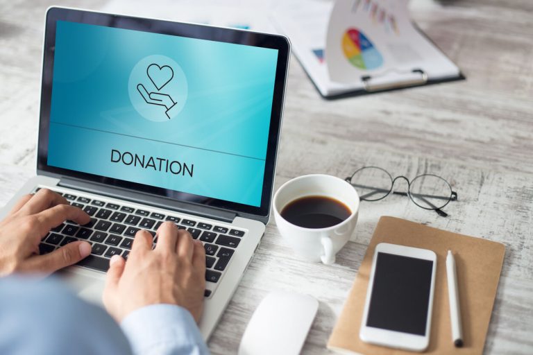 Researching how to donate money on a laptop