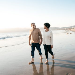 Retired couple walking on the beach