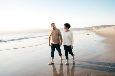 Retired couple walking on the beach