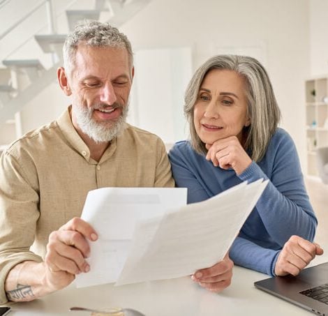 Couple looking at papers and laptop