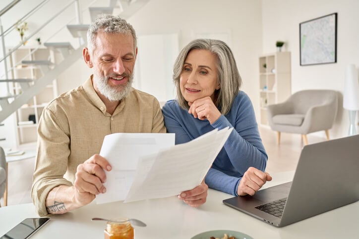 Couple looking at papers and laptop