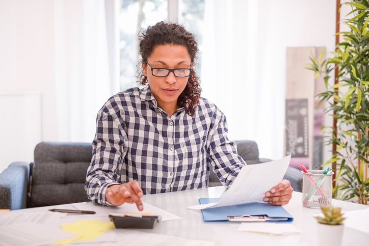 Woman using calculator