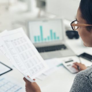 Woman looking at taxes and charts