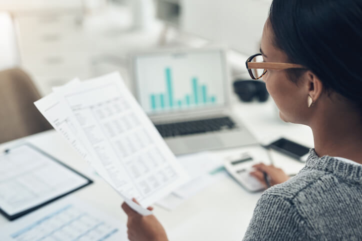 Woman looking at taxes and charts