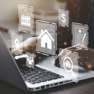 Person using computer with real estate icons
