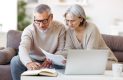 Couple working on taxes with laptop and papers