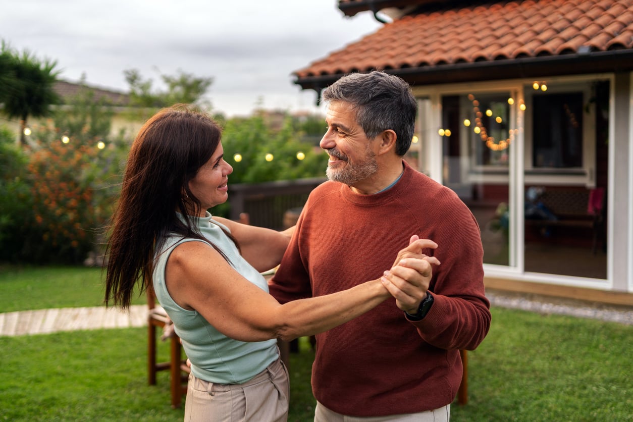 retired couple dancing outside