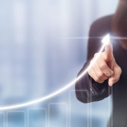 Woman pointing at a graph trending upwards