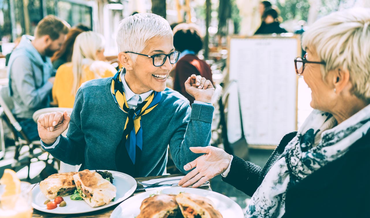 Senior women chatting while eating