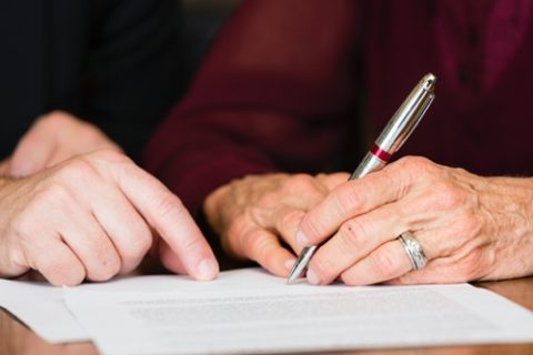 two people writing out a will