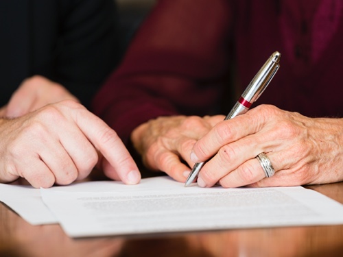 two people writing out a will