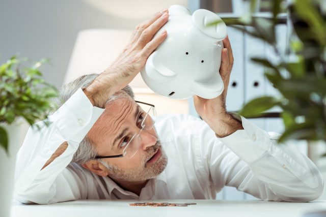 Adult man with piggy bank.