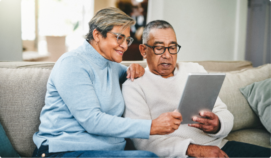 Retired couple browses 1-year annuity rates on a tablet