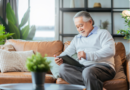 A senior man uses a tablet to research annuity rates