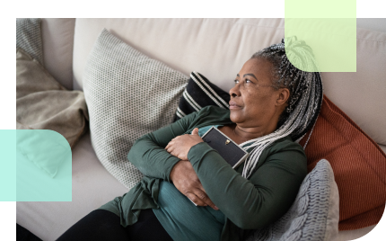 Older widowed woman, embracing a picture frame